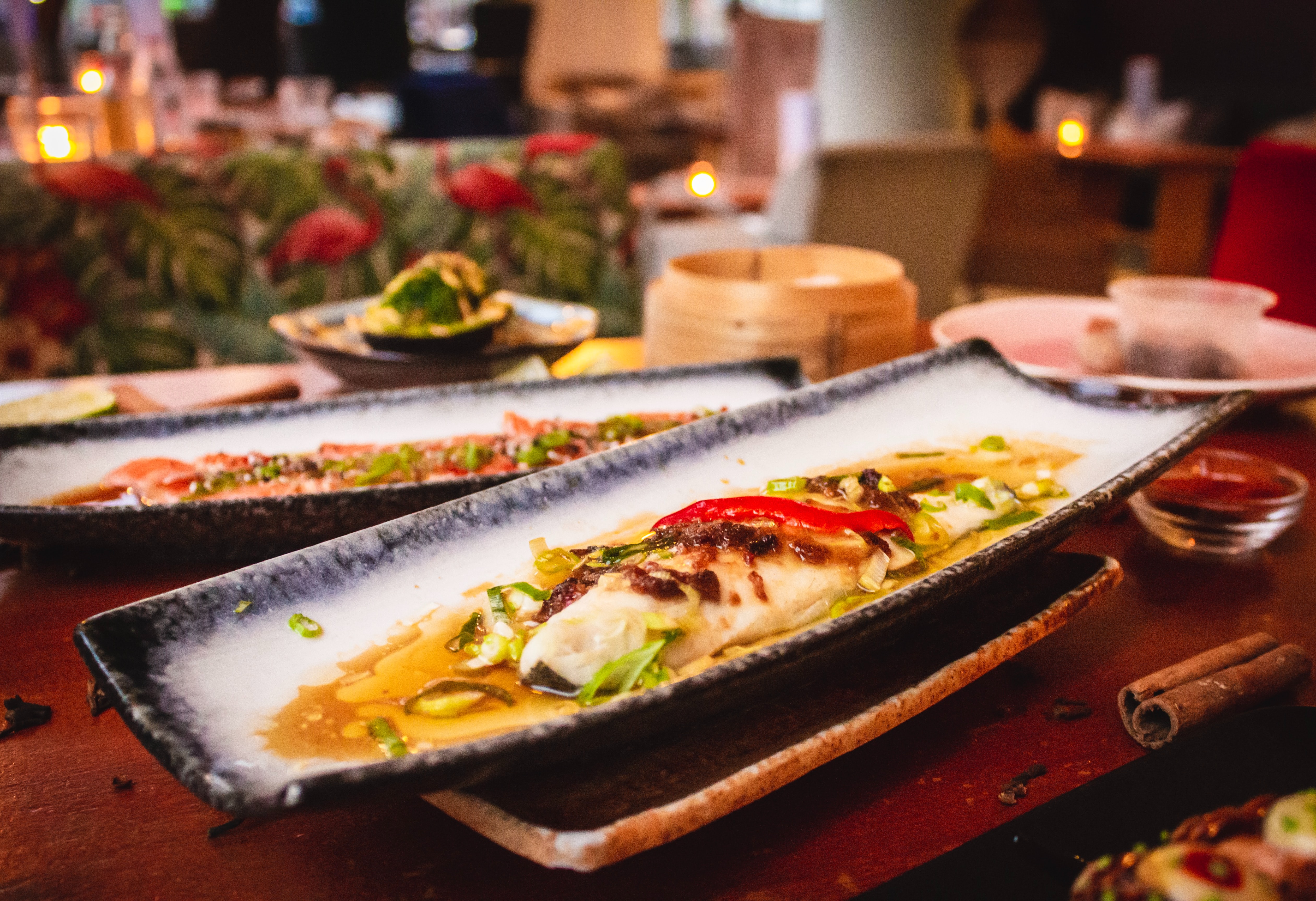 A meal served on a long rectangular ceramic dish in a restaurant